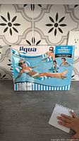 Front of box shows Aqua Monterey Inflatable Water Hammock with images of usage