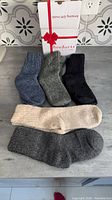 Five pairs of thick knit women’s socks laid out with BenSorts gift box