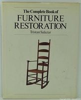Front cover of hardcover book showing title and chair image