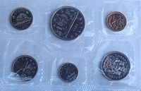 Obverse designs of six sealed coins (beaver 5¢, voyageur $1, maple leaf 1¢, caribou 25¢, Bluenose 10¢, coat-of-arms 50¢)