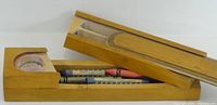 Open box showing interior compartments and three crayons