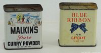 Front view of both spice tins showing brand names and graphics