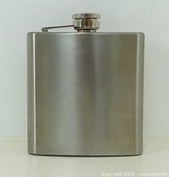 Front view of brushed stainless steel hip flask