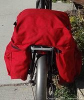 Rear view of red pannier mounted on bike rack
