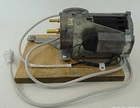 Side view showing motor, pump housing, brass barbs, power cord
