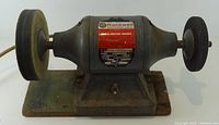 Front view of Rockwell bench grinder showing both wheels and base