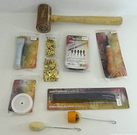 Group shot of all nine leather working items in packaging