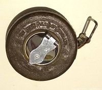 Top view of leather-cased Lufkin tape measure showing brand embossing and metal winding lever
