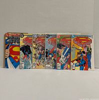 Front view showing all six bagged comics standing side-by-side