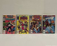 Front view of four bagged and boarded What If…? Vol. 2 issues 1, 2, 4 and 6 standing upright