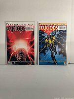 Front view of both Cyclops comics issues 1 and 4 in bags with boards