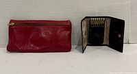 Red leather pouch and open black leather key holder showing 6 key hooks