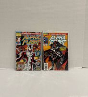 Front view of both Alpha Flight comic books bagged and boarded