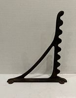 Full view of triangular cast iron bracket standing upright