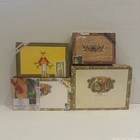 Front view showing all five assorted cigar boxes upright for identification of brands and condition