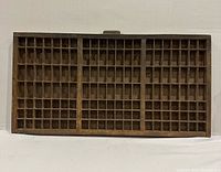 Front view of wooden letterpress case showing compartment grid