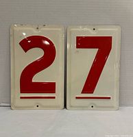 Front view showing both metal signs with numbers 2 and 7
