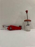 Can opener and whisk jar side by side