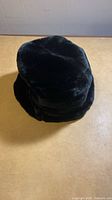 Black plush hat exterior view