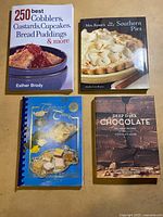 Four cookbooks laid out showing front covers