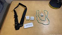 Overall lot showing belt, necklace, earrings on table
