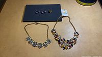 Full lot: two necklaces, stud earrings, ring