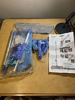 Full contents of mop kit including handle poles, microfiber pad, spray bottle, trigger parts and instructions