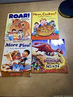 Group of four picture books laid on table
