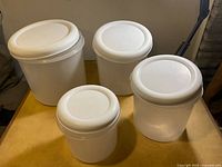 All four containers with lids in place