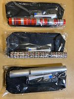 Three packaged travel toothbrush sets showing patterns and pouches