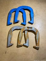 Four horseshoes laid out showing colors and condition