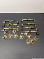 Drawer pulls and rosettes laid out on black surface