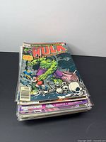 Stack of bagged comics with The Incredible Hulk issue on top