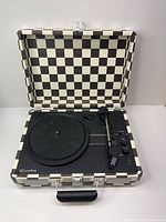 Suitcase-style Crosley record player open, checkerboard case visible