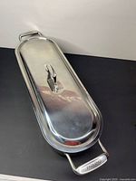 Top view of closed stainless steel fish steamer showing lid and handle