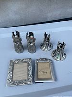 Group shot showing all pewter candle holders and two frames