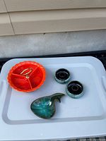 Entire lot showing orange divided bowl, two small green bowls, leaf dish