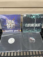 All four vinyl records laid out showing two Culture Beat picture sleeves and two plain sleeves with labels
