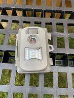 Front view showing lens, motion sensor, LED array and Simmons logo