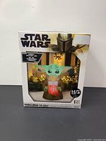 Front of retail box showing Star Wars The Mandalorian The Child inflatable