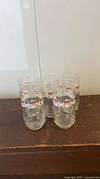 Set of four Esso tiger glasses on wooden surface