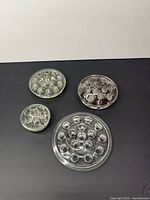 Top view of four round glass flower frogs