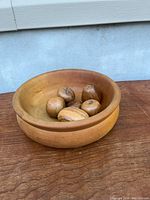 wooden bowl with five fruit pieces