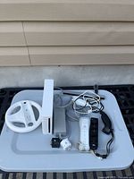 Overview of Nintendo Wii console with accessories on tray
