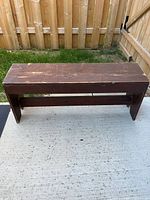 Full view of bench on concrete showing overall design and size