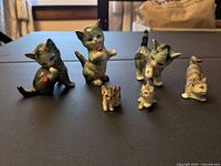 Front view of six cat figurines