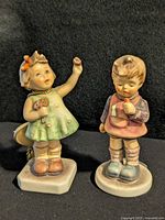 Front view of both M. I. Hummel figurines
