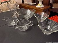 Overview of six etched glass pieces on table