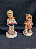 Front view of both Hummel figurines