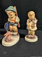 Front view of both Hummel figurines